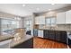 Modern kitchen featuring dark cabinets, granite countertops, and stainless steel appliances at 11200 E 166Th Ave, Brighton, CO 80602