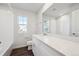 Well-lit bathroom with a white vanity, quartz countertop, and a large mirror over the sink at 1416 Orchard St, Brighton, CO 80601