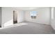 Bright, carpeted bedroom offering a window with views and an ensuite bathroom at 1416 Orchard St, Brighton, CO 80601