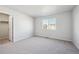 Comfortable bedroom featuring a view to the neighborhood, plush carpet, and easy access to a walk-in closet at 1416 Orchard St, Brighton, CO 80601
