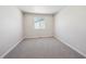 Neutral bedroom offers a cozy space with plush carpeting and a window for natural light at 1416 Orchard St, Brighton, CO 80601