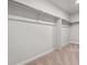 An empty walk-in closet space with wall to wall metal bars for organizing clothing at 1416 Orchard St, Brighton, CO 80601