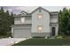 Charming two-story home features a well-maintained lawn, two-car garage and welcoming entrance at 1416 Orchard St, Brighton, CO 80601