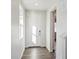Bright hallway with natural light, featuring wood floors, white walls, and a welcoming entrance at 1416 Orchard St, Brighton, CO 80601
