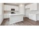 Modern kitchen featuring white cabinets, quartz countertops, stainless steel appliances and island at 1416 Orchard St, Brighton, CO 80601