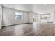 Spacious, bright living room with hardwood floors and an open layout to the kitchen at 1416 Orchard St, Brighton, CO 80601