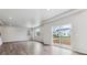 Bright, open living area with hardwood floors, and sliding door access to an outdoor patio at 1416 Orchard St, Brighton, CO 80601