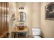 Powder room with rustic vanity, wood accents, and modern toilet at 21798 Wagon Rim Trl, Morrison, CO 80465