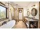 Bathroom featuring a soaking tub, dual sinks, and glass enclosed shower at 21798 Wagon Rim Trl, Morrison, CO 80465