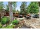 Inviting backyard featuring a flagstone patio, outdoor dining, landscaped garden beds, and mature trees at 6248 E Mineral Pl, Centennial, CO 80112