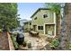 Charming backyard with flagstone patio, outdoor dining area, lush landscaping, and a cozy grill space at 6248 E Mineral Pl, Centennial, CO 80112