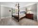 Carpeted main bedroom features a ceiling fan and a four-poster bed with side tables and lamps at 6248 E Mineral Pl, Centennial, CO 80112