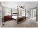 Bedroom with neutral carpet and paint features a four poster bed, ceiling fan, and closet at 6248 E Mineral Pl, Centennial, CO 80112