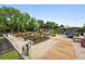 Vibrant community garden featuring raised garden beds, wooden walkways, seating, and mature shade trees at 6248 E Mineral Pl, Centennial, CO 80112