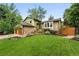 Charming two-story home featuring a brick facade, lush lawn, and inviting landscape at 6248 E Mineral Pl, Centennial, CO 80112