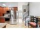 Modern kitchen with stainless steel appliances, granite countertops, and easy access to staircase at 6248 E Mineral Pl, Centennial, CO 80112
