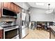 Modern kitchen with stainless steel appliances, breakfast nook, and easy access to staircase at 6248 E Mineral Pl, Centennial, CO 80112