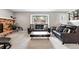 Spacious living room features plush carpeting, large window views, and stylish brick fireplace at 6248 E Mineral Pl, Centennial, CO 80112