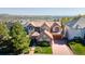 Beautiful aerial view of a stone home showcasing its tile roof and mature landscaping at 16713 W Archer Ave, Golden, CO 80401