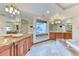 A luxurious bathroom boasting double vanities, granite counters and a soaking tub at 16713 W Archer Ave, Golden, CO 80401