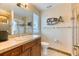 A modern bathroom featuring a glass-enclosed shower, wood vanity and unique shelving at 16713 W Archer Ave, Golden, CO 80401