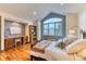A cozy bedroom boasts hardwood floors, a large window, and a built-in desk area at 16713 W Archer Ave, Golden, CO 80401