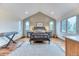 An airy bedroom features hardwood floors, vaulted ceilings, and dual windows for lots of light at 16713 W Archer Ave, Golden, CO 80401