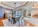 Elegant dining room with a chandelier, coffered ceiling, wood floors, and access to the foyer at 16713 W Archer Ave, Golden, CO 80401
