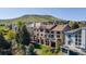 Back exterior showing multi-level decks, mature trees, and view of the mountain at 16713 W Archer Ave, Golden, CO 80401