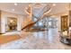Grand foyer featuring a circular staircase, travertine floors and a chandelier at 16713 W Archer Ave, Golden, CO 80401
