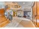 Grand foyer features a curved staircase, travertine flooring, and an elegant dining room at 16713 W Archer Ave, Golden, CO 80401