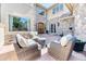 Cozy front patio with stylish wicker furniture and a stone accent wall at 16713 W Archer Ave, Golden, CO 80401