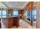 Close-up of a chef's kitchen featuring an island, stainless steel appliances, and tile floors at 16713 W Archer Ave, Golden, CO 80401