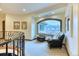 A well-lit landing features comfortable seating and a large arched window with neighborhood views at 16713 W Archer Ave, Golden, CO 80401