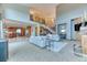 Open-concept living room features a staircase, fireplace, and seamless flow to the kitchen at 16713 W Archer Ave, Golden, CO 80401