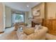 Comfortable living room with a fireplace, wooden cabinets, sofas, and a large window at 16713 W Archer Ave, Golden, CO 80401