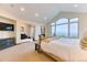 Comfortable main bedroom featuring large windows, a sitting area, and neutral decor at 16713 W Archer Ave, Golden, CO 80401