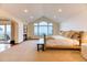 Spacious main bedroom with fireplace, high ceilings, and large windows showcasing mountain views at 16713 W Archer Ave, Golden, CO 80401