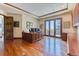 Spacious home office with hardwood floors, wood trim, large desk, and natural light at 16713 W Archer Ave, Golden, CO 80401