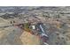 Expansive aerial view of a property featuring a modern home on a large lot with mature trees and rural charm at 428 N Perry Park Rd, Sedalia, CO 80135