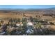 Elevated view of the home, surrounded by trees and a large field at 428 N Perry Park Rd, Sedalia, CO 80135