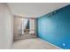 Bedroom featuring a bright blue accent wall, carpeted floors and large window at 428 N Perry Park Rd, Sedalia, CO 80135