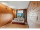 Cozy bedroom with wood paneled wall, hardwood floors and window at 428 N Perry Park Rd, Sedalia, CO 80135