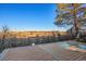 View from deck overlooking a grassy field under a clear, blue sky, with a large shade tree at 428 N Perry Park Rd, Sedalia, CO 80135