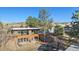 Wide angle of home exterior with trees, patio, and basketball hoop at 428 N Perry Park Rd, Sedalia, CO 80135