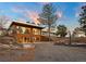 Charming two-story home with large windows, inviting entry, and a well-maintained yard with basketball court at 428 N Perry Park Rd, Sedalia, CO 80135