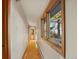 A well-lit hallway featuring wood floors, and a large window with views of the outdoors at 428 N Perry Park Rd, Sedalia, CO 80135