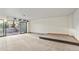 Large living room with walkout to backyard, carpeted floors and tiered platform at 428 N Perry Park Rd, Sedalia, CO 80135