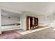 Spacious living room with hardwood floors, bright walls, and dark wood entertainment center at 428 N Perry Park Rd, Sedalia, CO 80135