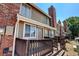 Exterior view of townhome with deck and brick facade at 17102 E Baltic Dr # F, Aurora, CO 80013